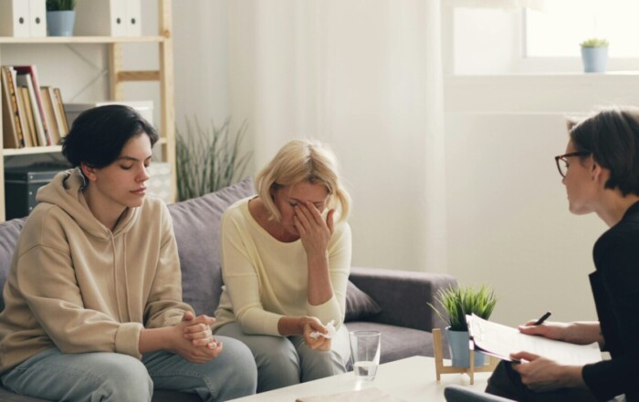 Family gathered at home for a compassionate intervention, discussing support and recovery options.