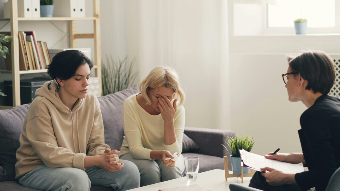 Family gathered at home for a compassionate intervention, discussing support and recovery options.